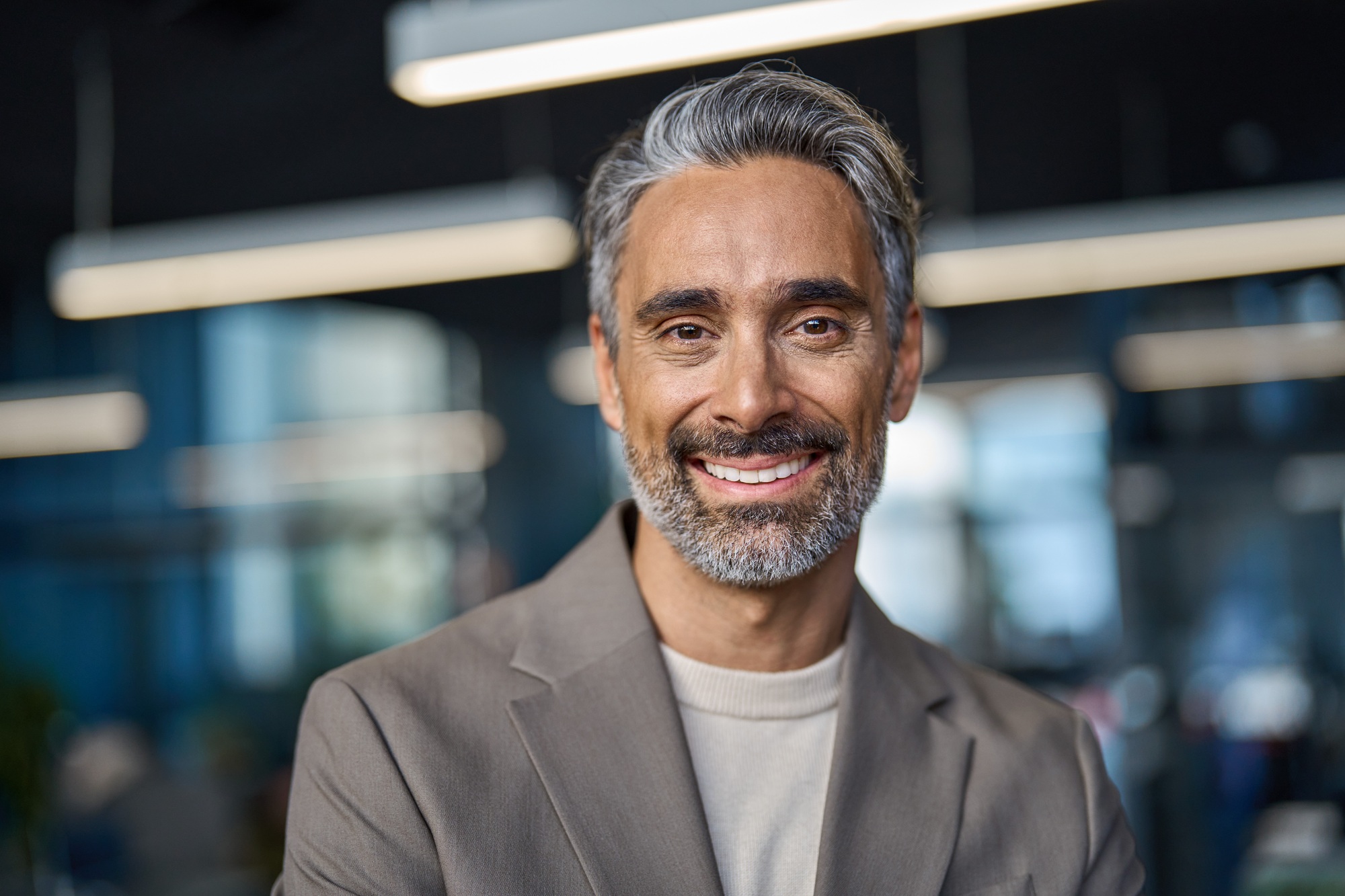 Happy middle aged mature business man looking at camera in office, headshot.