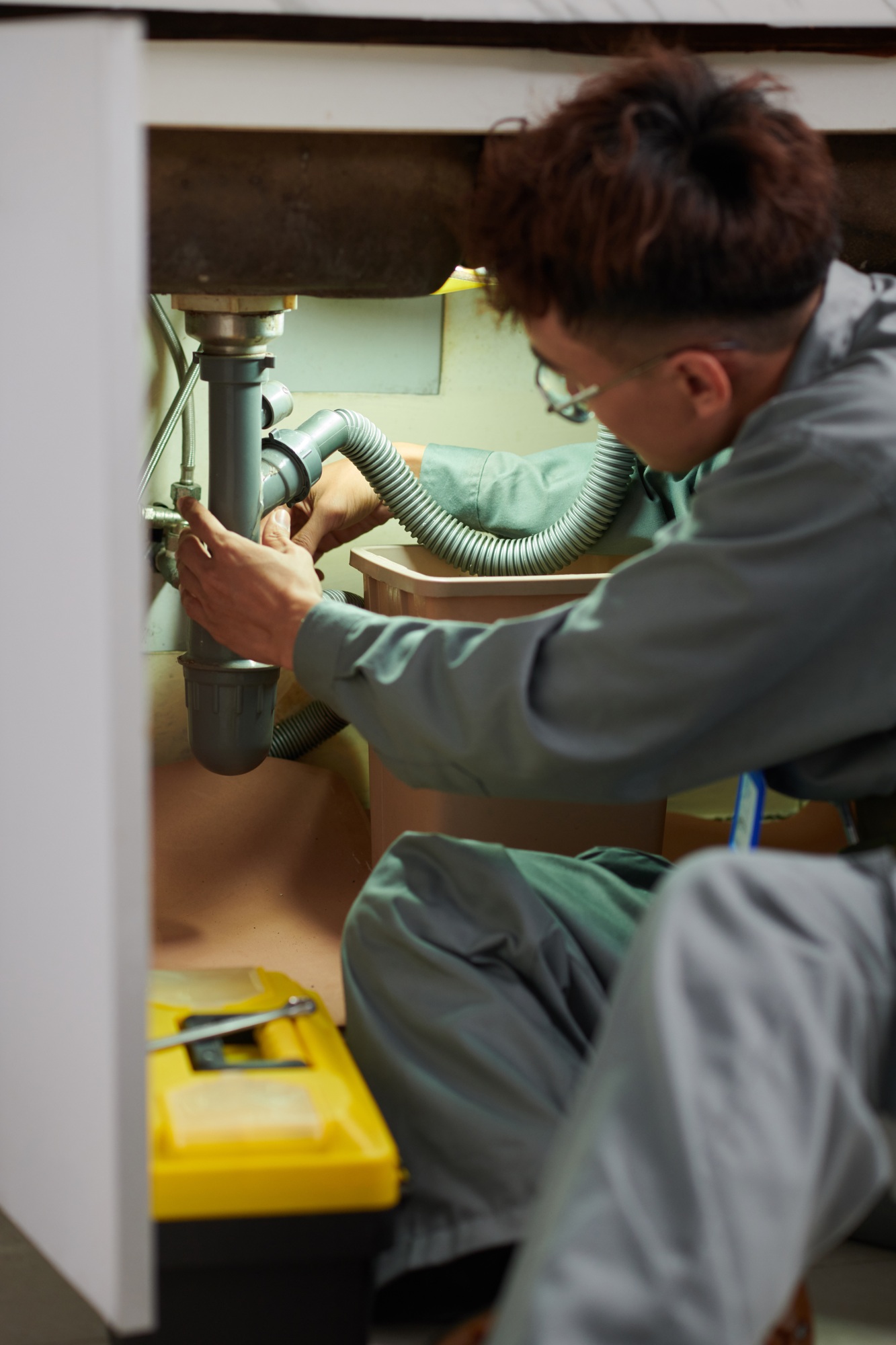 Plumber Unclogging Sink